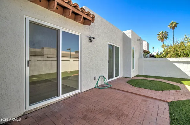 a view of a backyard with flat screen tv and outdoor seating