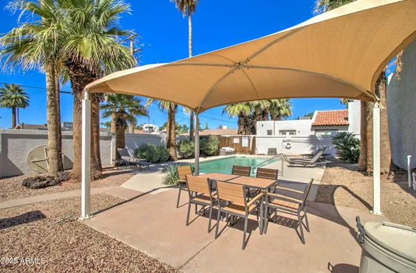 a view of a patio with swimming pool table and chairs