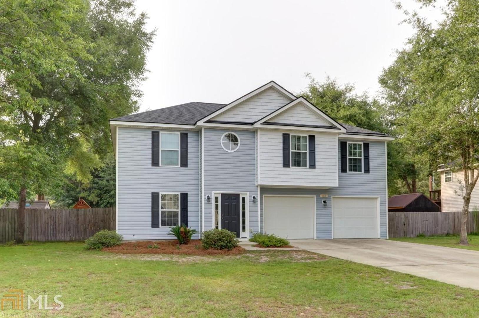 102 Fox Trace Rincon, GA 31326 - Photo 1 of 1 a front view of a house with a yard and garage