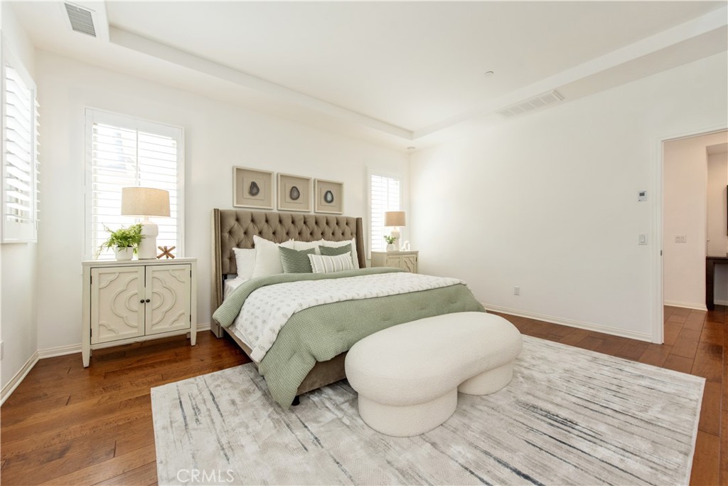 238 Shelbourne Irvine, CA 92620 - Photo 17 of 36 a bedroom with a bed and wooden floor