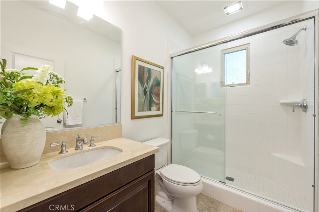 238 Shelbourne Irvine, CA 92620 - Photo 20 of 36 a bathroom with a granite countertop sink a toilet and shower