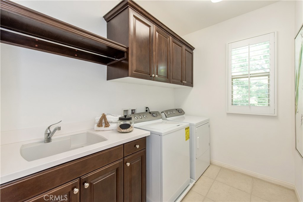 238 Shelbourne Irvine, CA 92620 - Photo 24 of 36 a utility room with sink dryer and washer