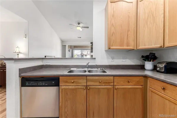 a kitchen with stainless steel appliances granite countertop a sink and a white cabinets