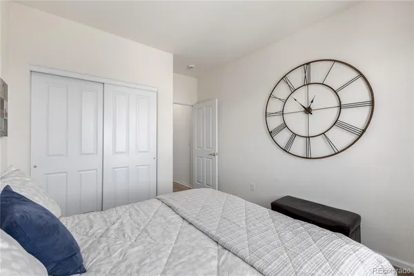 a bedroom with a bed and a mirror