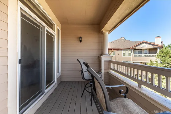 a view of a balcony with a chairs