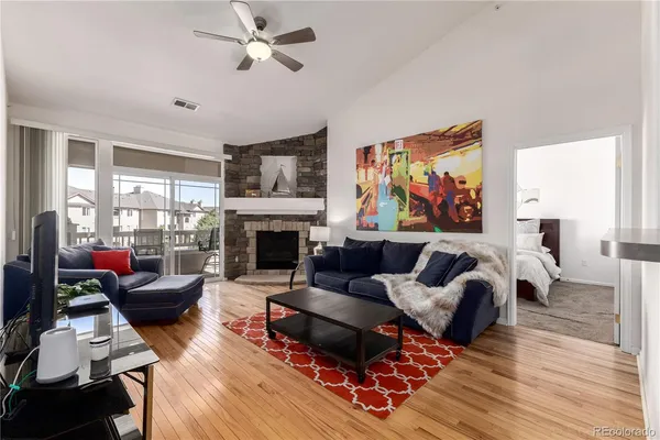 a living room with furniture fireplace and window