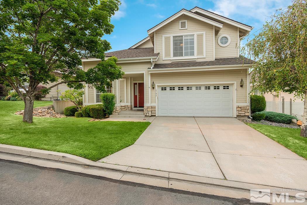 a front view of a house with a yard and garage