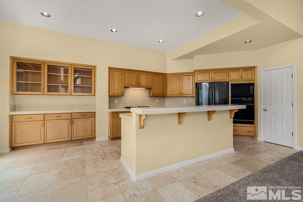 6142 Wycliffe Circle Reno, NV 89519 - Photo 3 of 29 a kitchen with stainless steel appliances granite countertop a stove a sink and a refrigerator
