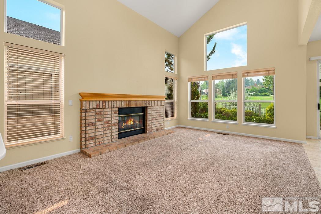 6142 Wycliffe Circle Reno, NV 89519 - Photo 8 of 29 a view of an empty room with a fireplace and a window