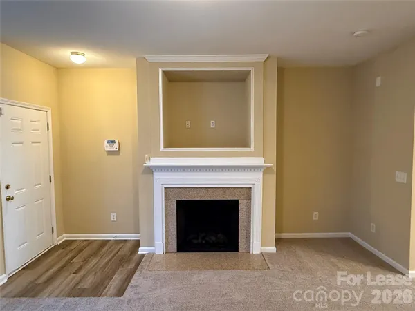 a view of an empty room with a fireplace