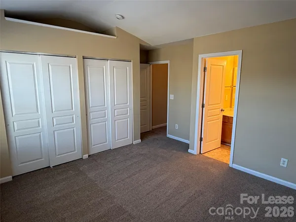 a view of an empty room with closet area