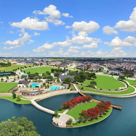 a view of a swimming pool with lawn chairs under an umbrella