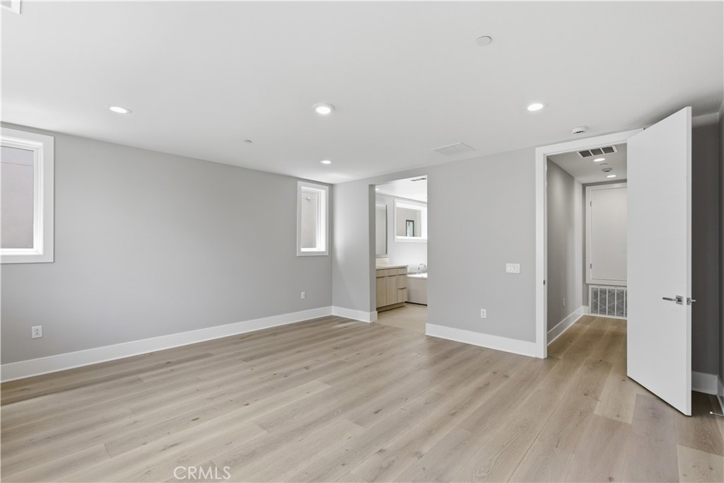 156 Apron Irvine, CA 92618 - Photo 30 of 40 a view of an empty room with wooden floor and a bathroom