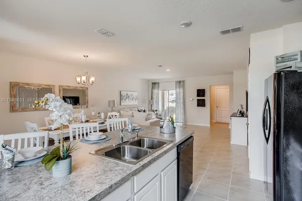 a large kitchen with a large counter top appliances and cabinets