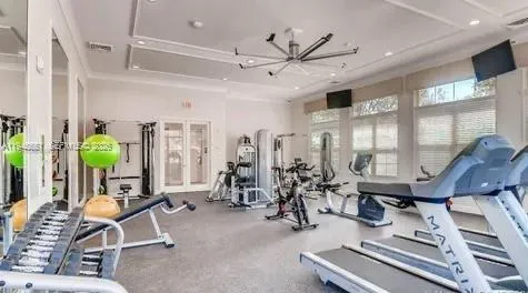 a room with gym equipment and large mirror
