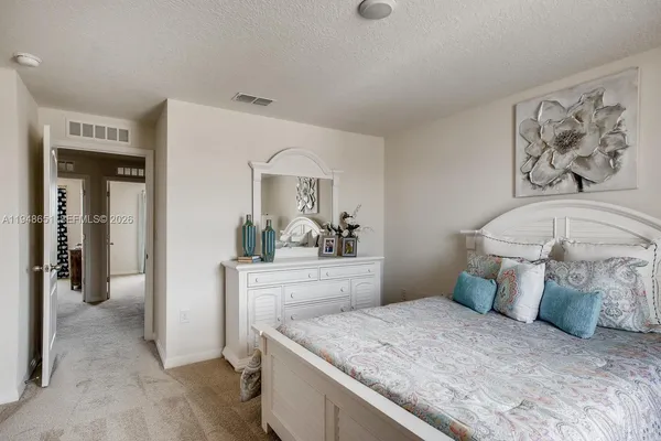 a bedroom with a bed and a mirror