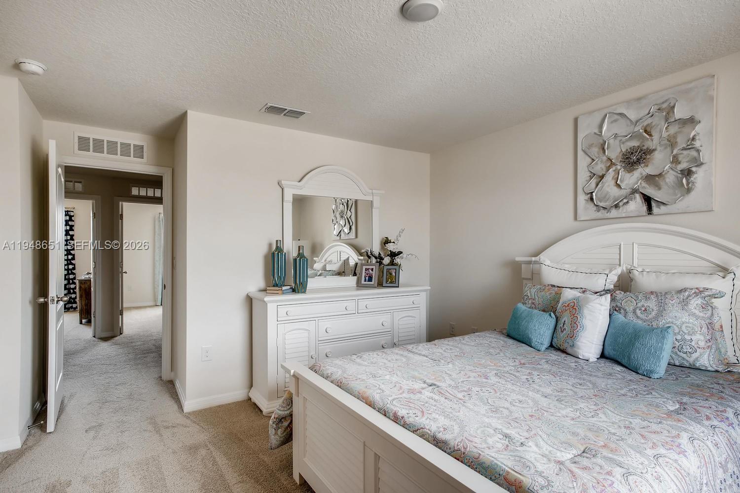 1563 Dawnview Way Kissimmee, FL 34744 - Photo 3 of 14 a bedroom with a bed and a mirror