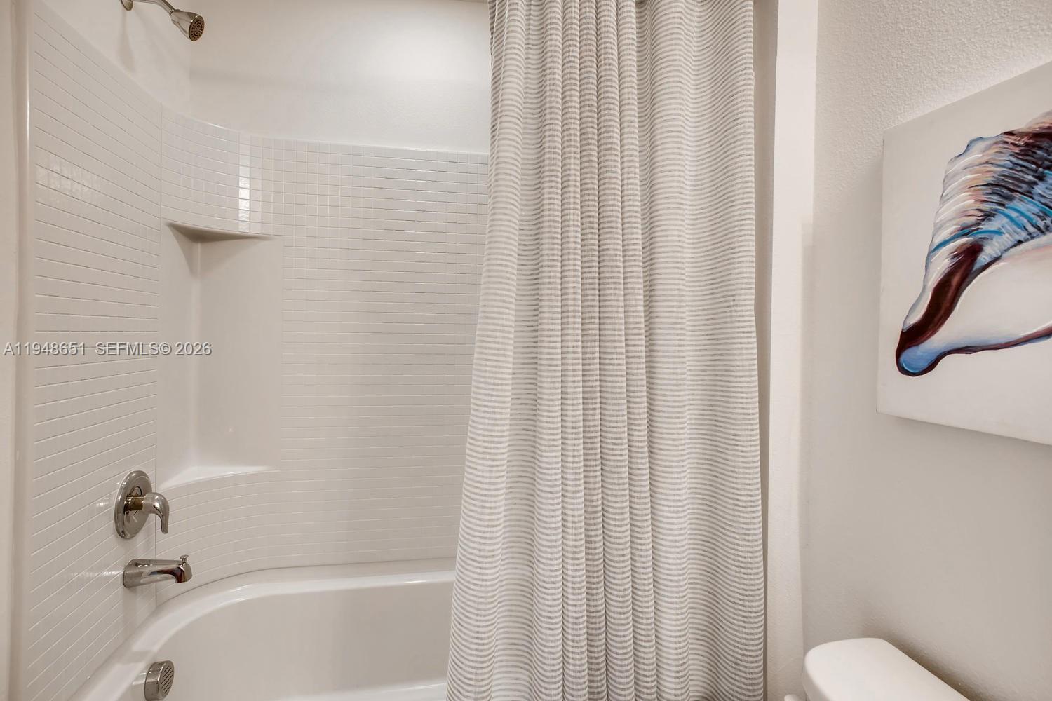 1563 Dawnview Way Kissimmee, FL 34744 - Photo 4 of 14 a bathroom with a shower curtain