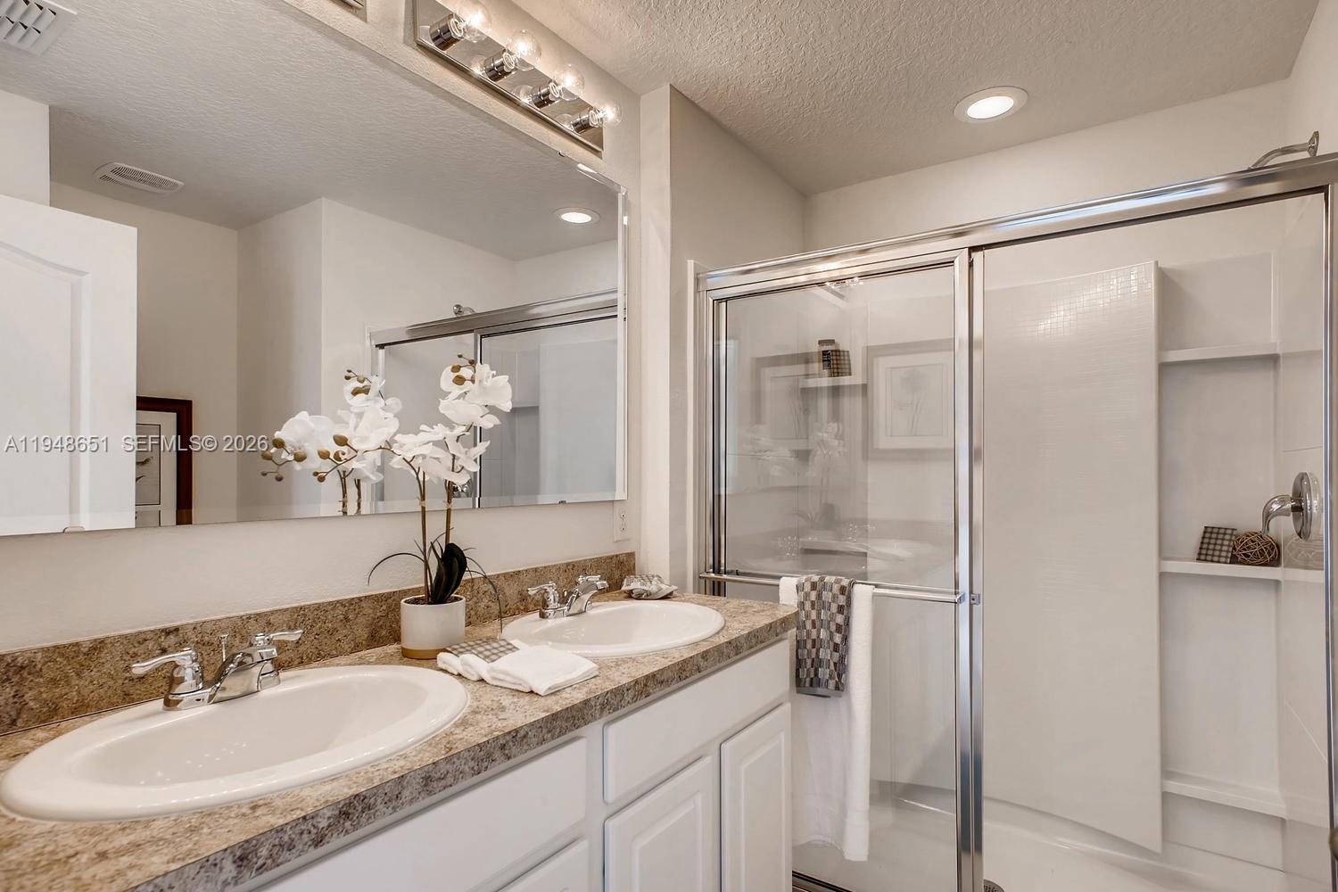 1563 Dawnview Way Kissimmee, FL 34744 - Photo 6 of 14 a bathroom with a granite countertop sink mirror and double