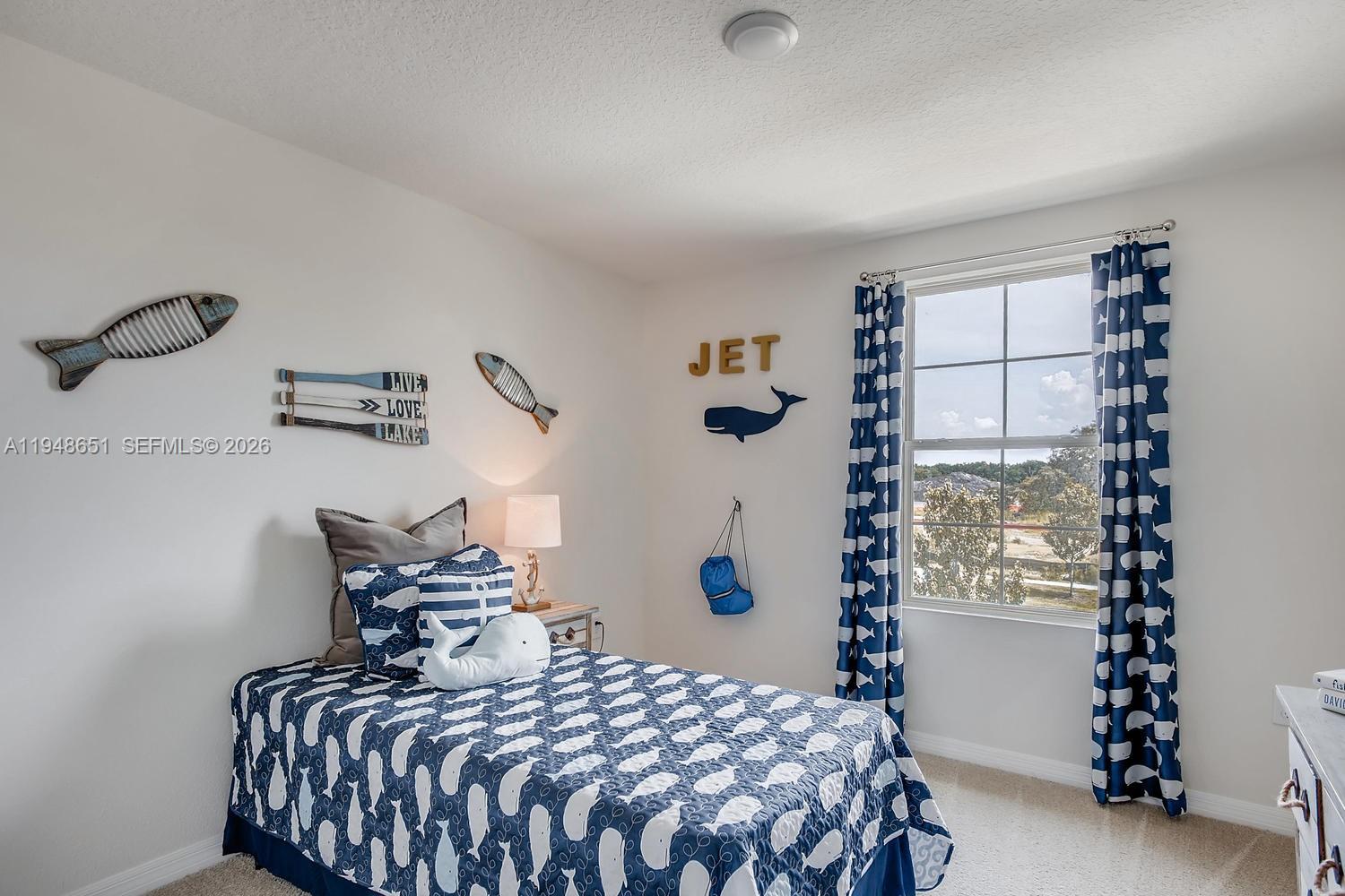 1563 Dawnview Way Kissimmee, FL 34744 - Photo 7 of 14 a bedroom with a bed and a window