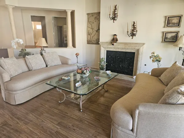 a living room with furniture and a fireplace