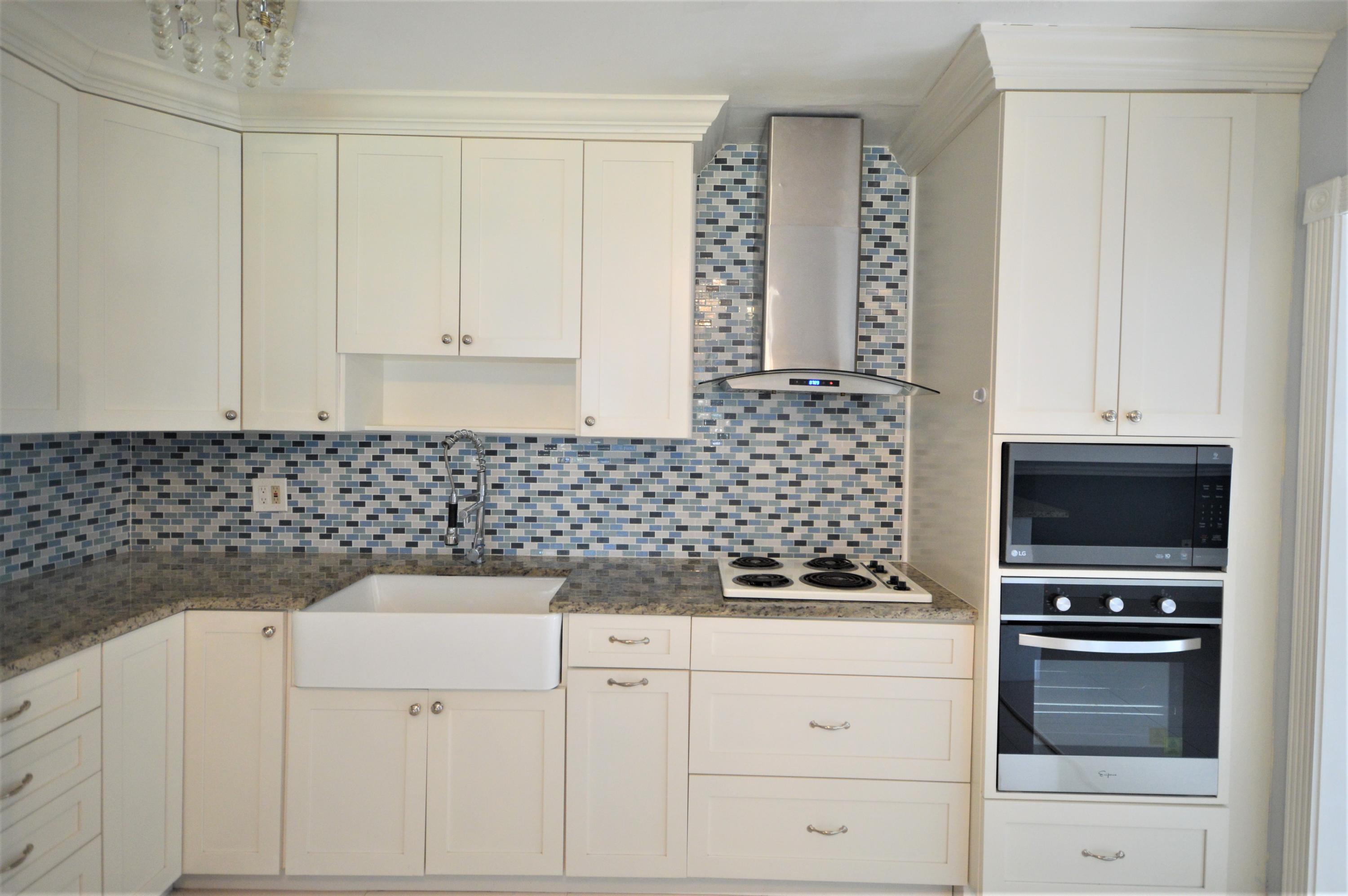 4092 Rochester Street Palm Beach Gardens, FL 33410 - Photo 13 of 28 a kitchen with a sink and cabinets