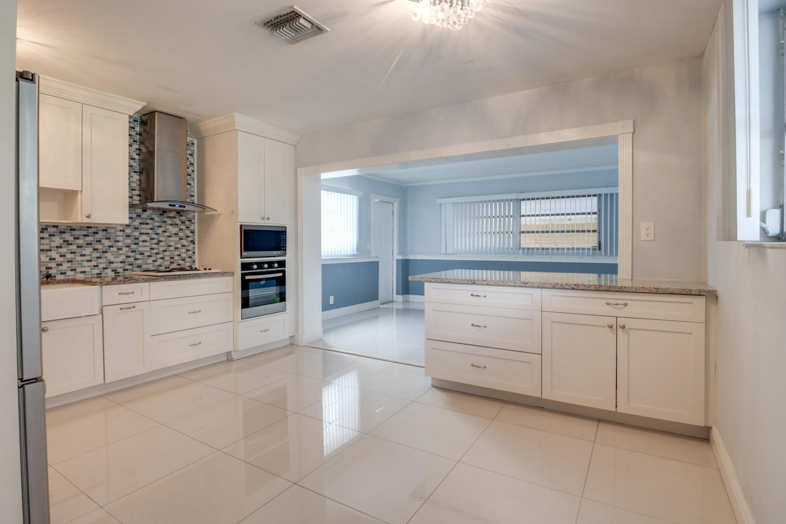 4092 Rochester Street Palm Beach Gardens, FL 33410 - Photo 15 of 28 a spacious bathroom with a granite countertop sink and a mirror