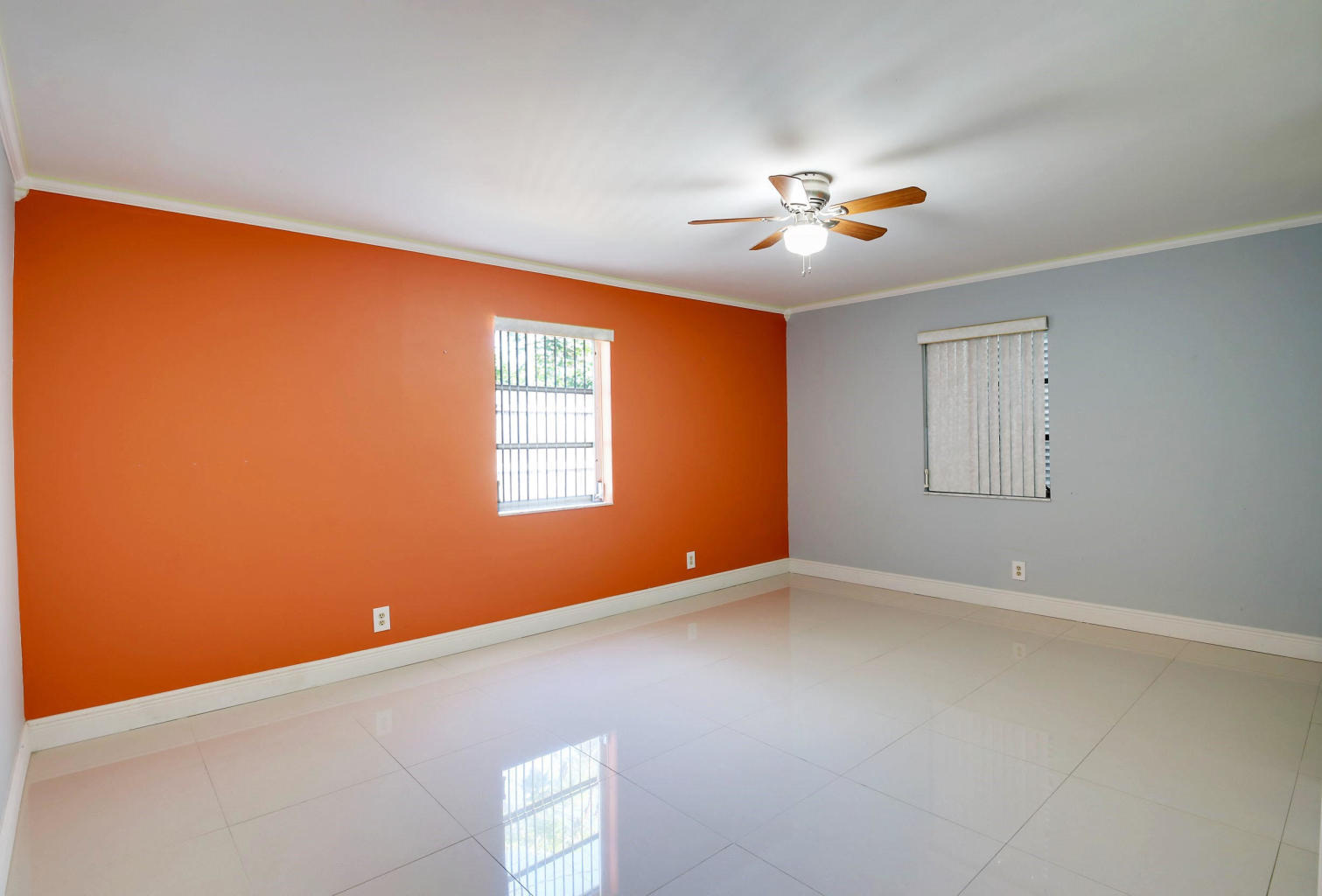 4092 Rochester Street Palm Beach Gardens, FL 33410 - Photo 18 of 28 an empty room with windows and fan