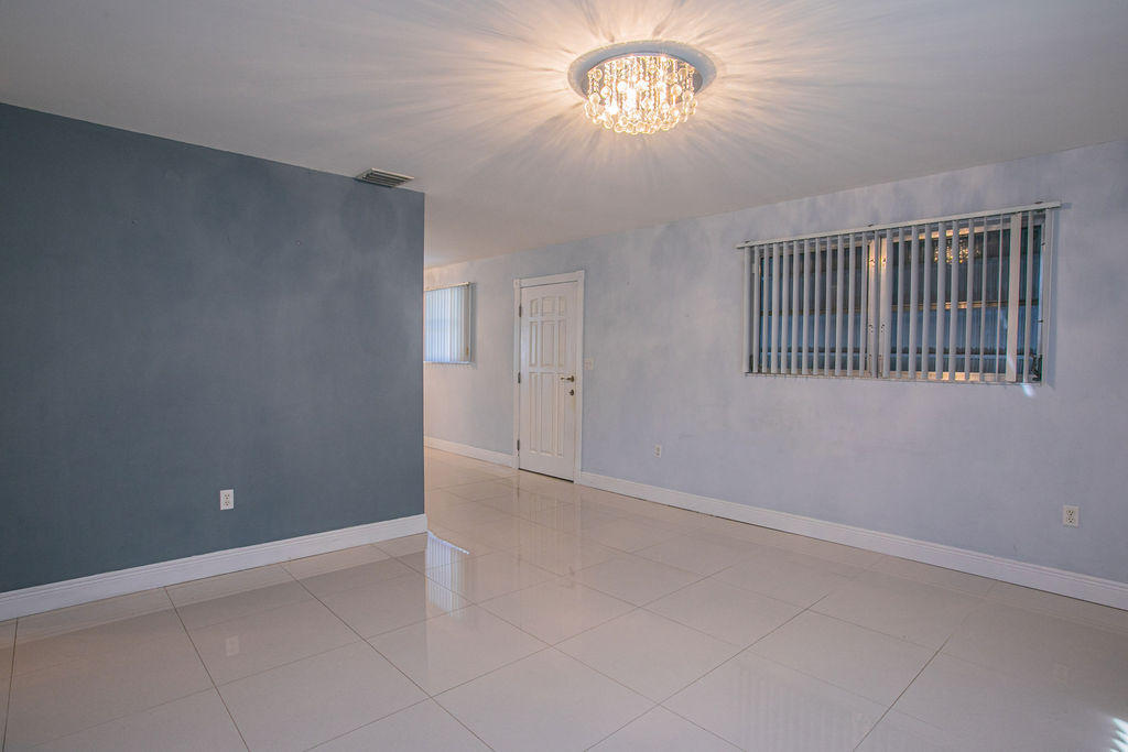 4092 Rochester Street Palm Beach Gardens, FL 33410 - Photo 19 of 28 an empty room with a view of a livingroom