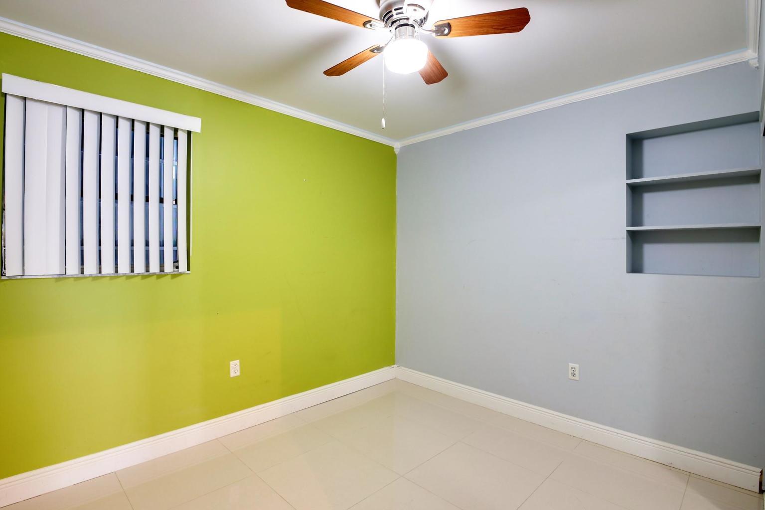 4092 Rochester Street Palm Beach Gardens, FL 33410 - Photo 20 of 28 a view of a room with a ceiling fan and window
