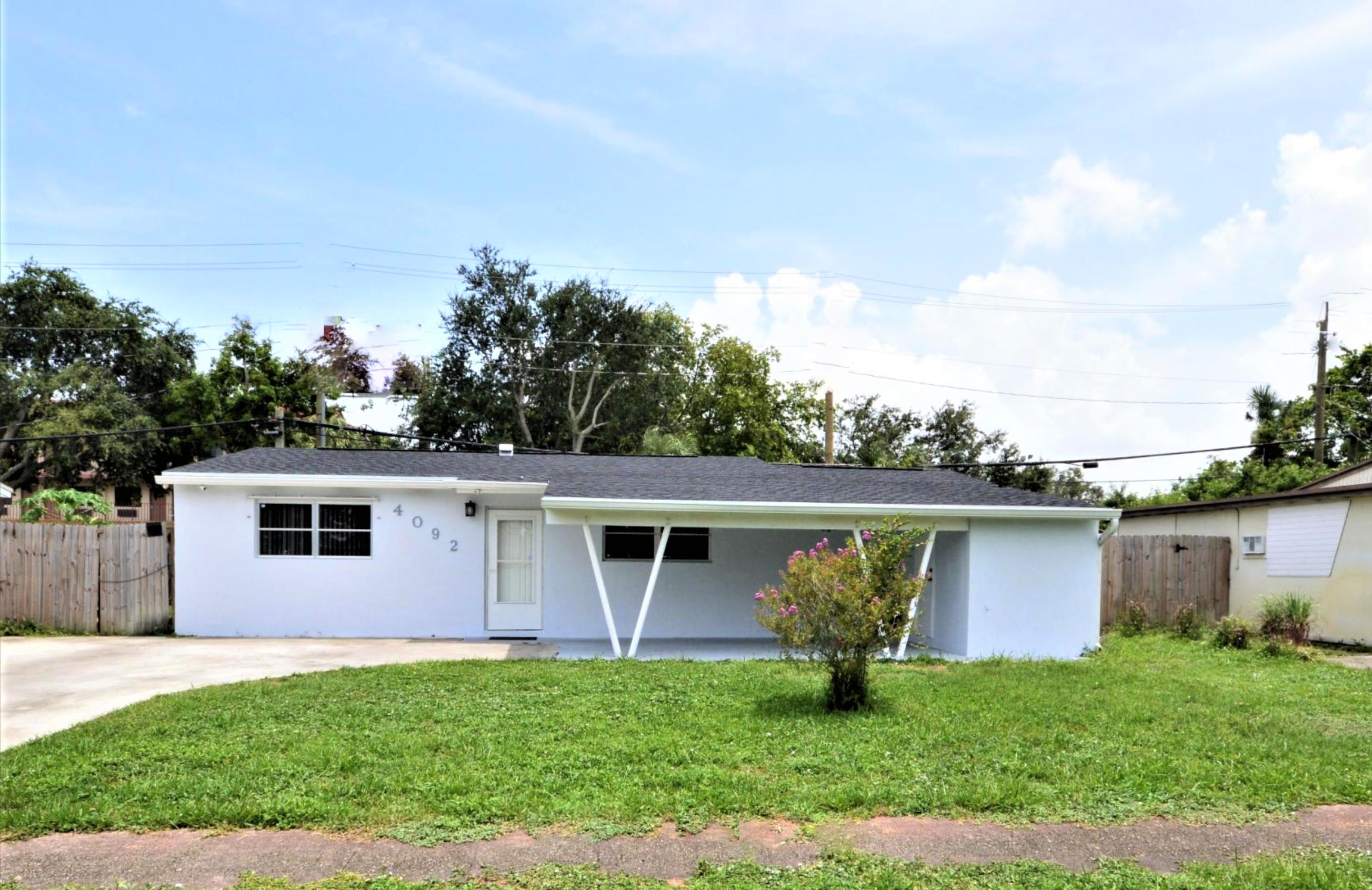 4092 Rochester Street Palm Beach Gardens, FL 33410 - Photo 2 of 28 a view of a house with a yard and a garden