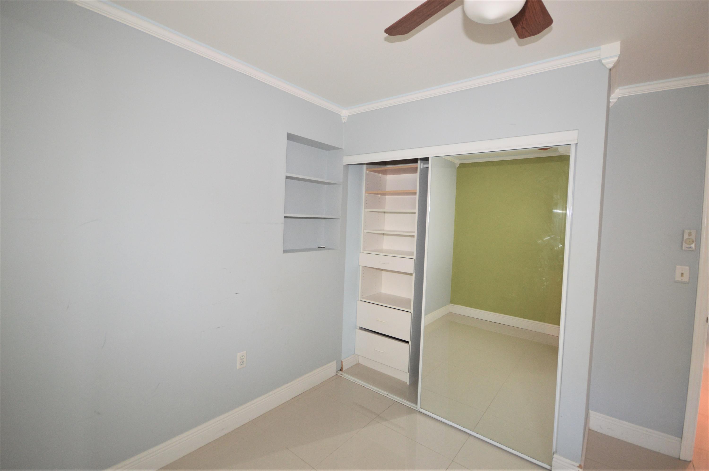 4092 Rochester Street Palm Beach Gardens, FL 33410 - Photo 22 of 28 a view of walk in closet with empty racks