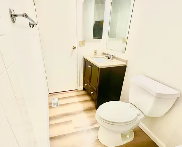 a white toilet sitting next to a bathroom sink