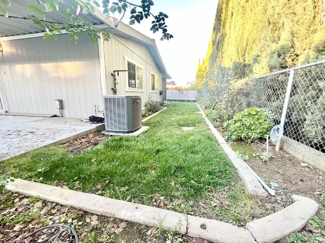 a view of a house with a yard and pathway