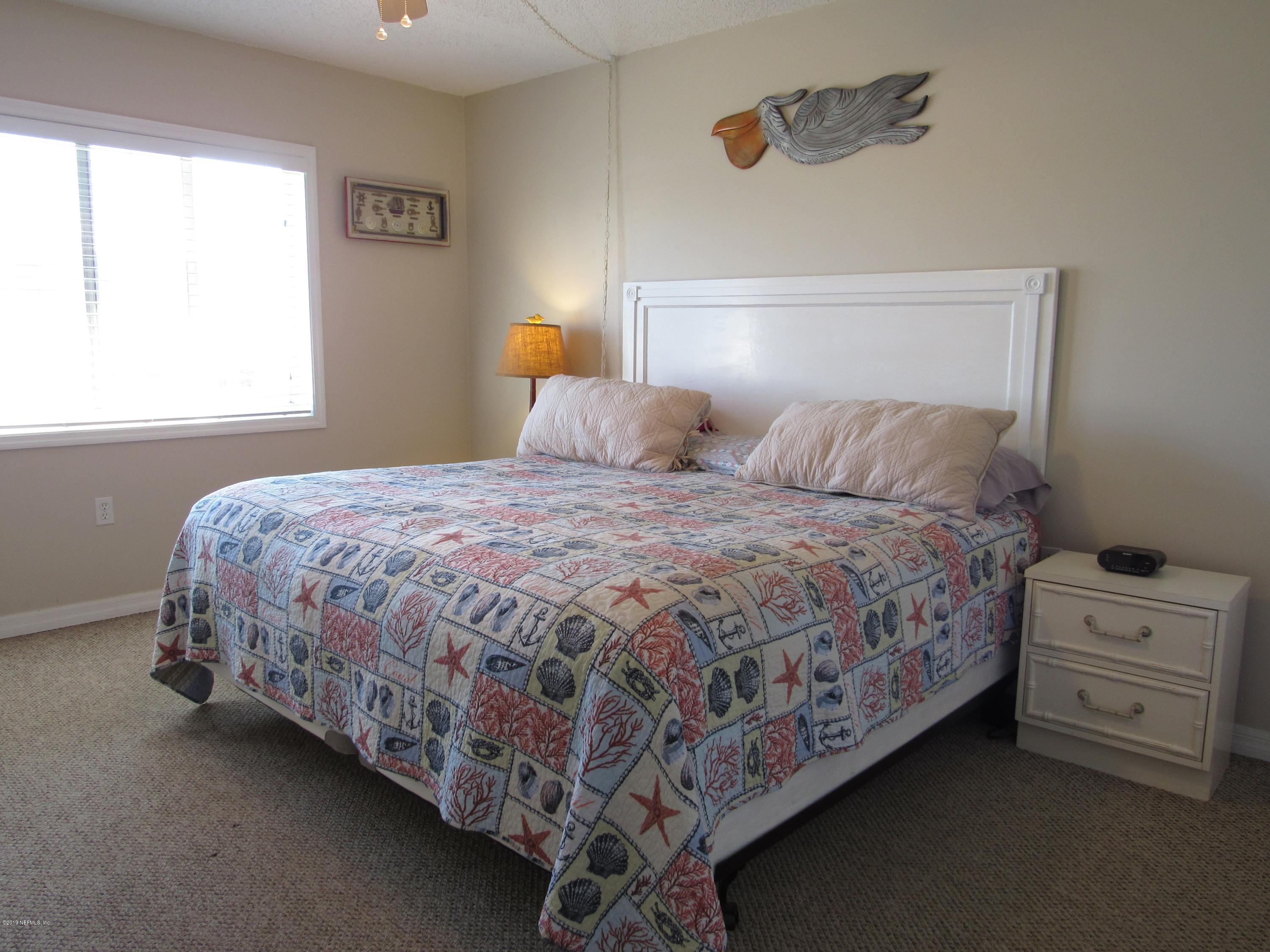 7175 South A1a Street, Unit B212 St. Augustine, FL 32080 - Photo 11 of 29 a bedroom with a bed and a window