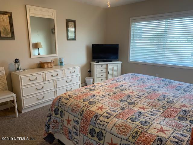 7175 South A1a Street, Unit B212 St. Augustine, FL 32080 - Photo 12 of 29 a bedroom with a bed and a flat screen tv
