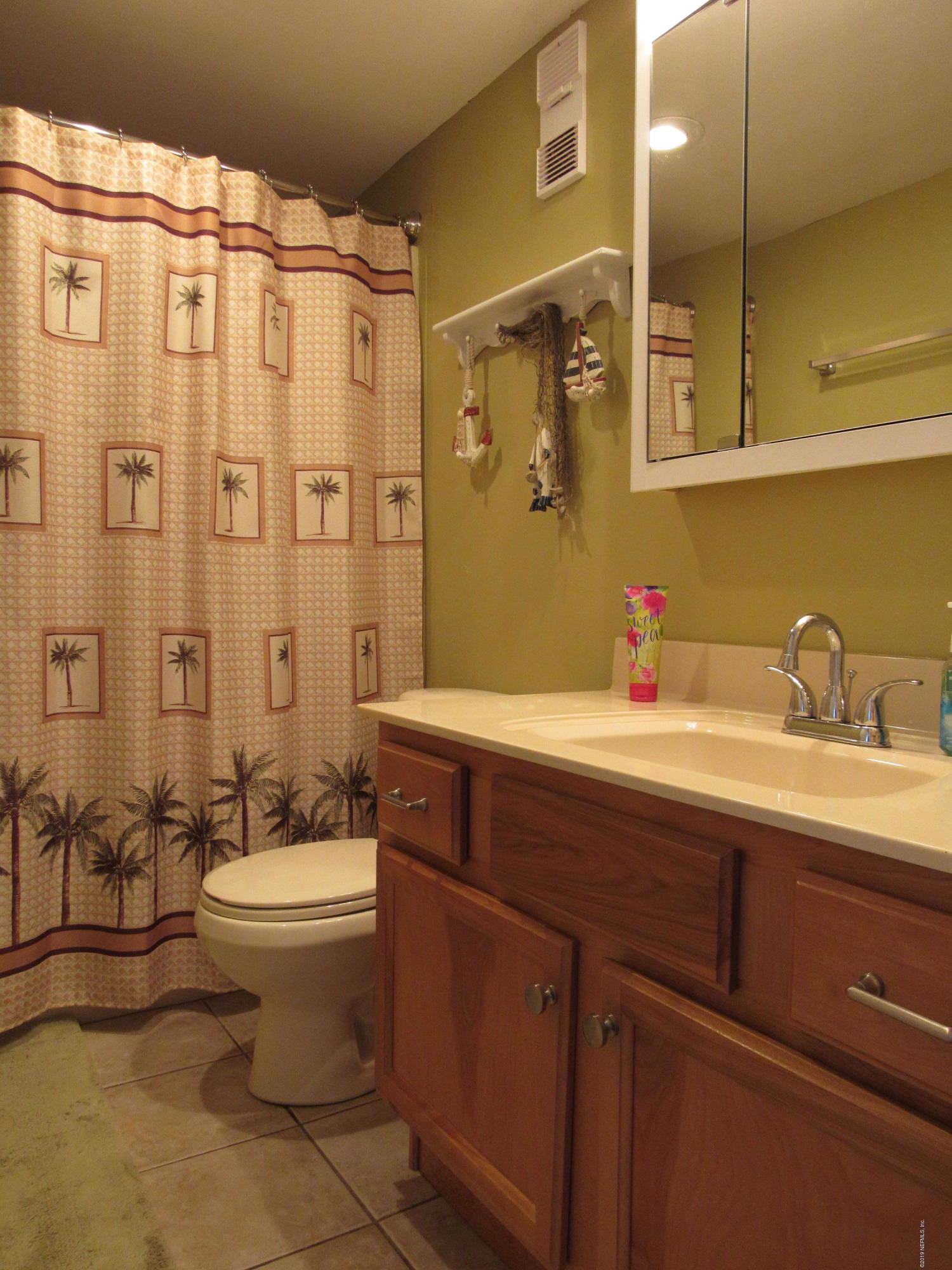 7175 South A1a Street, Unit B212 St. Augustine, FL 32080 - Photo 13 of 29 a bathroom with a sink mirror toilet and shower