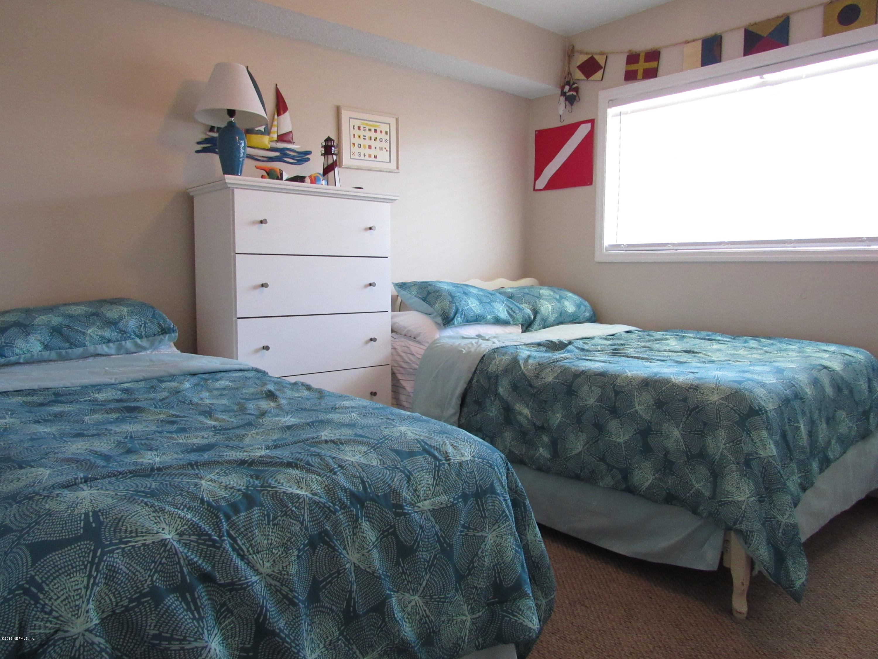 7175 South A1a Street, Unit B212 St. Augustine, FL 32080 - Photo 14 of 29 a bedroom with two beds and a window