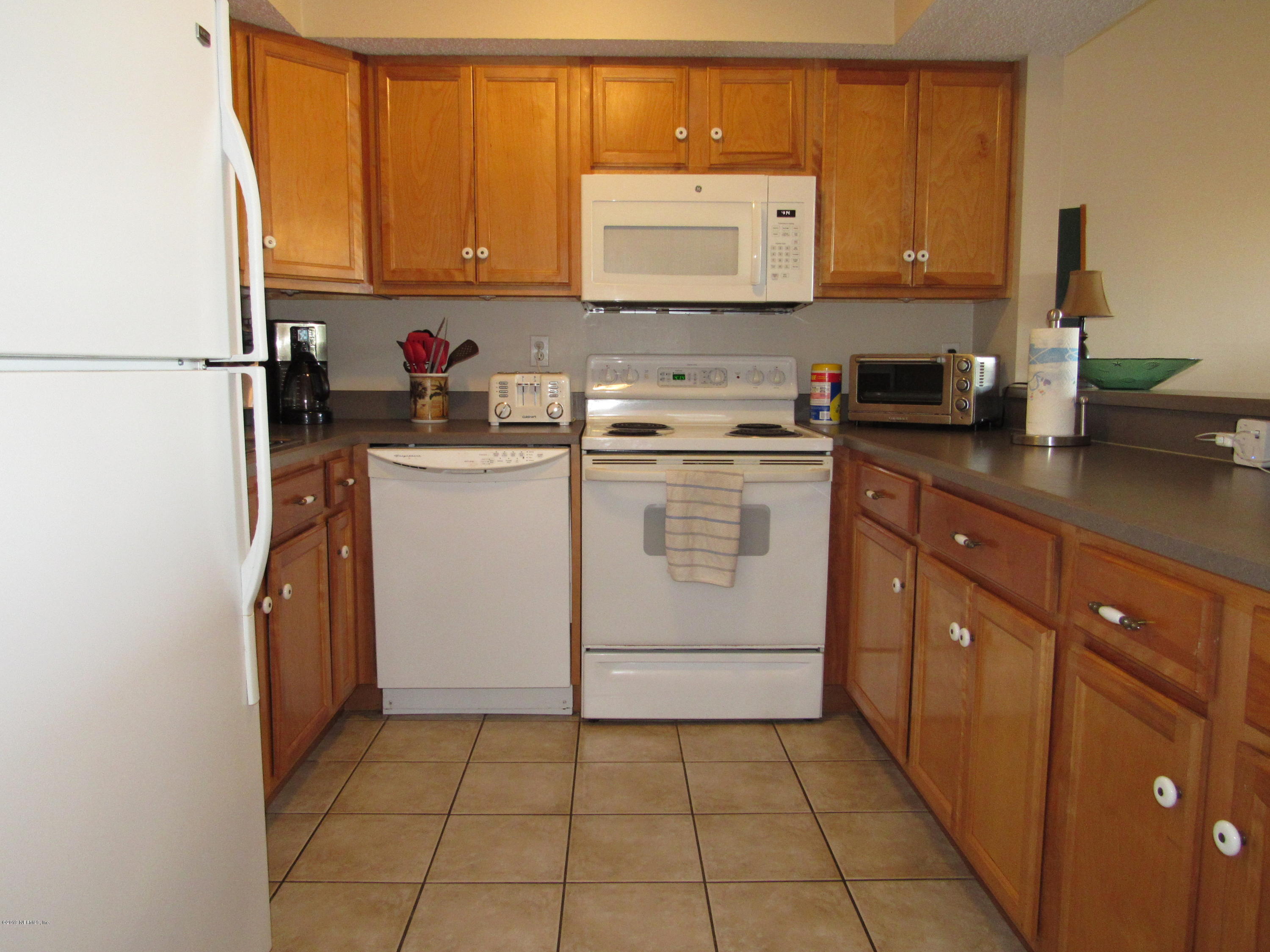 7175 South A1a Street, Unit B212 St. Augustine, FL 32080 - Photo 4 of 29 a kitchen with a sink cabinets and appliances