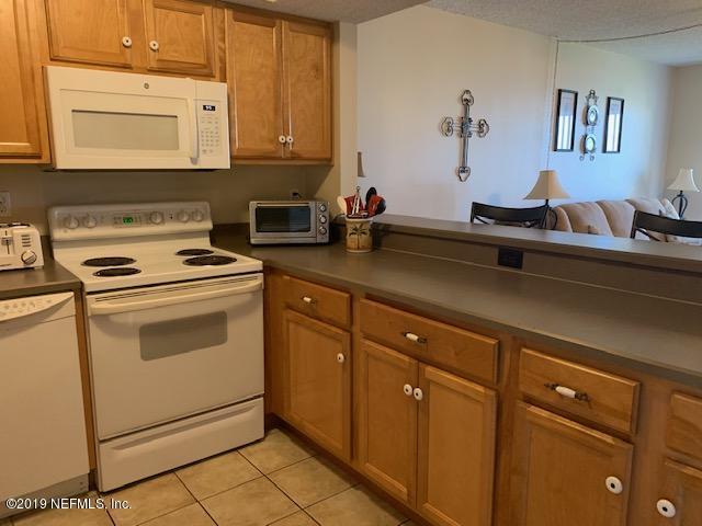 7175 South A1a Street, Unit B212 St. Augustine, FL 32080 - Photo 5 of 29 a kitchen with cabinets appliances and a counter top