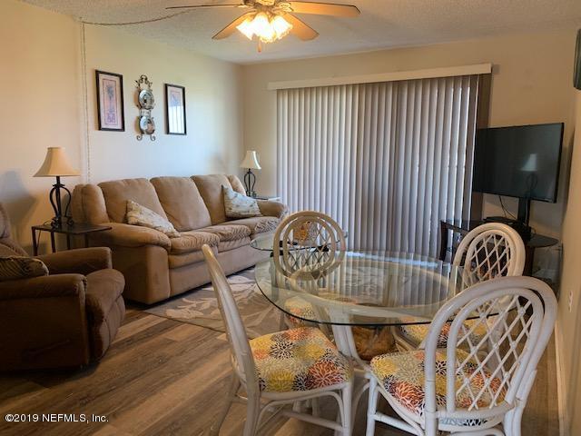 7175 South A1a Street, Unit B212 St. Augustine, FL 32080 - Photo 7 of 29 a bedroom with furniture and wooden floor