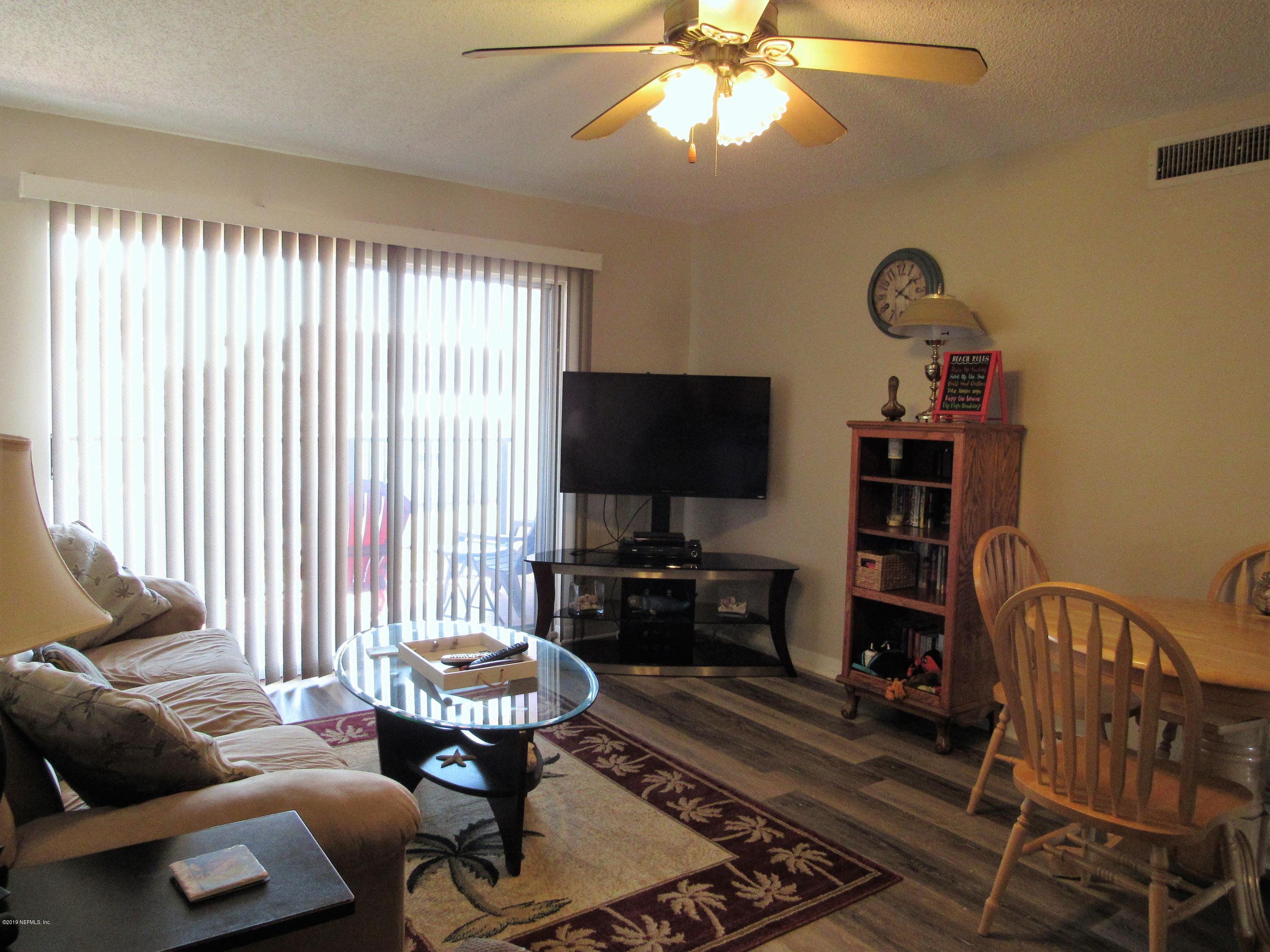 7175 South A1a Street, Unit B212 St. Augustine, FL 32080 - Photo 8 of 29 a living room with furniture and a flat screen tv