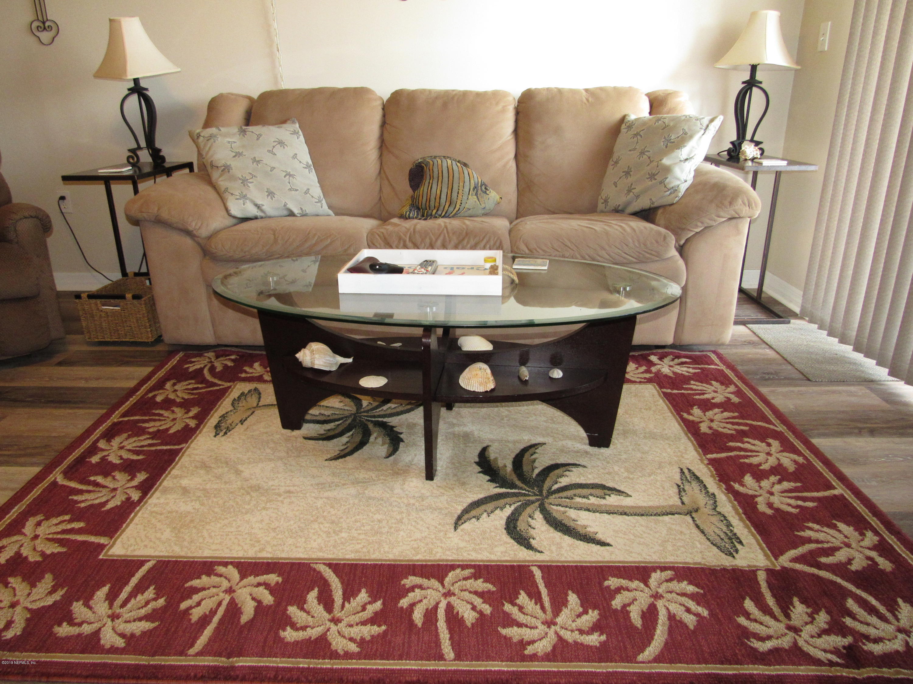 7175 South A1a Street, Unit B212 St. Augustine, FL 32080 - Photo 9 of 29 a living room with furniture and a rug