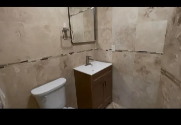 a bathroom with a shower and a sink