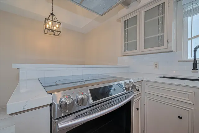 a stove top oven sitting inside of a kitchen