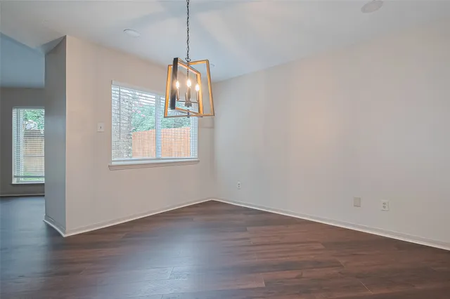 a view of wooden floor and windows in a room