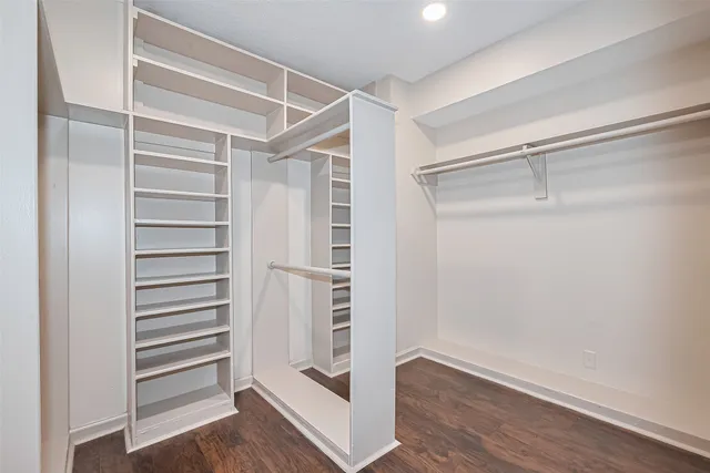 a view of walk in closet with empty racks