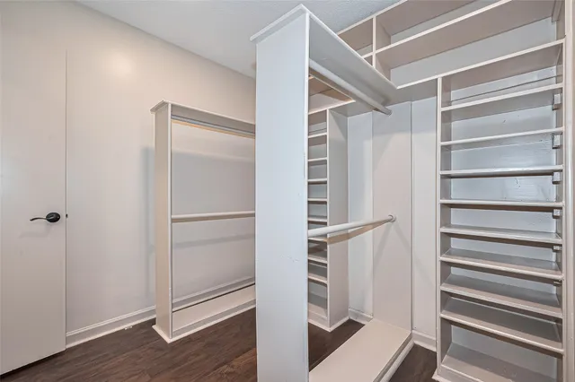 a view of walk in closet with empty racks