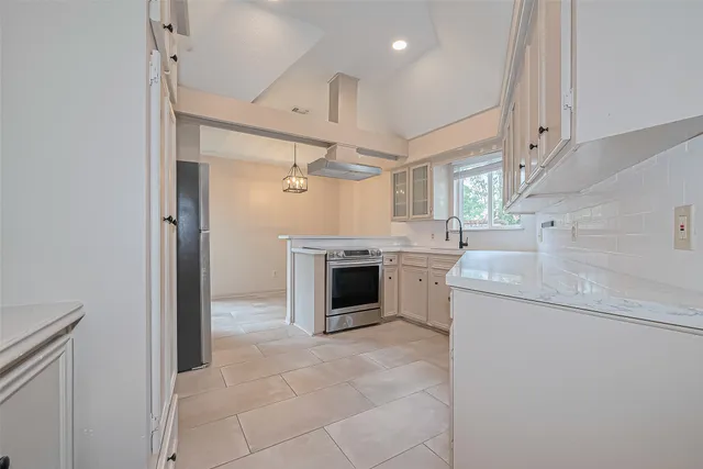 a view of a kitchen with a sink dryer and washer
