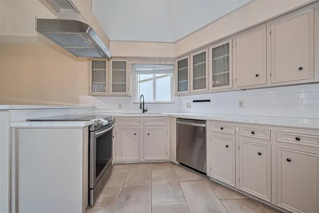 a kitchen with stainless steel appliances granite countertop a sink stove and cabinets